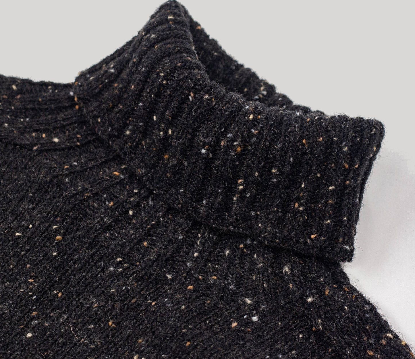 Merino Wool Donegal Roll Neck Jumper in Black Tweed